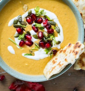 Butternut squash soup with sour cream, pomegranates and pumpkin seeds cropped